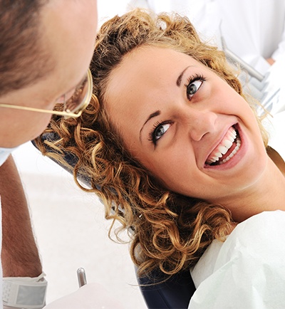 Pretty woman smiling at dentist