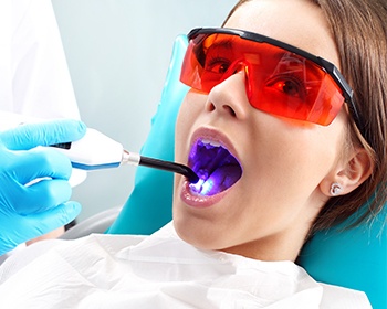 girl with red sunglasses getting dental sealants