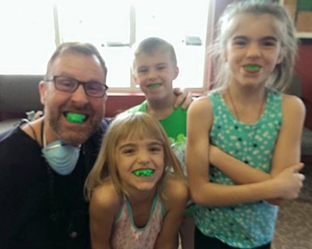 Kids and dentist with mouthguards in