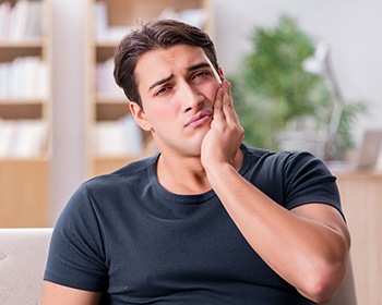 Pained man worried about the cost of dental emergencies in Lincoln