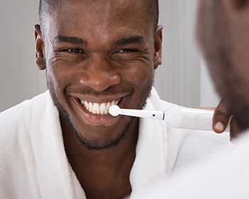 Man brushing teeth to prevent dental emergencies in Lincoln