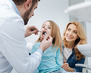 young girl getting dental exam