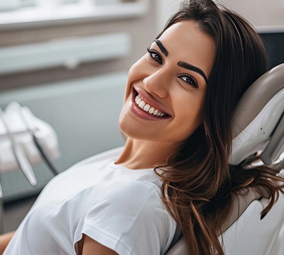 smiling patient leaning back in the dentist’s chair